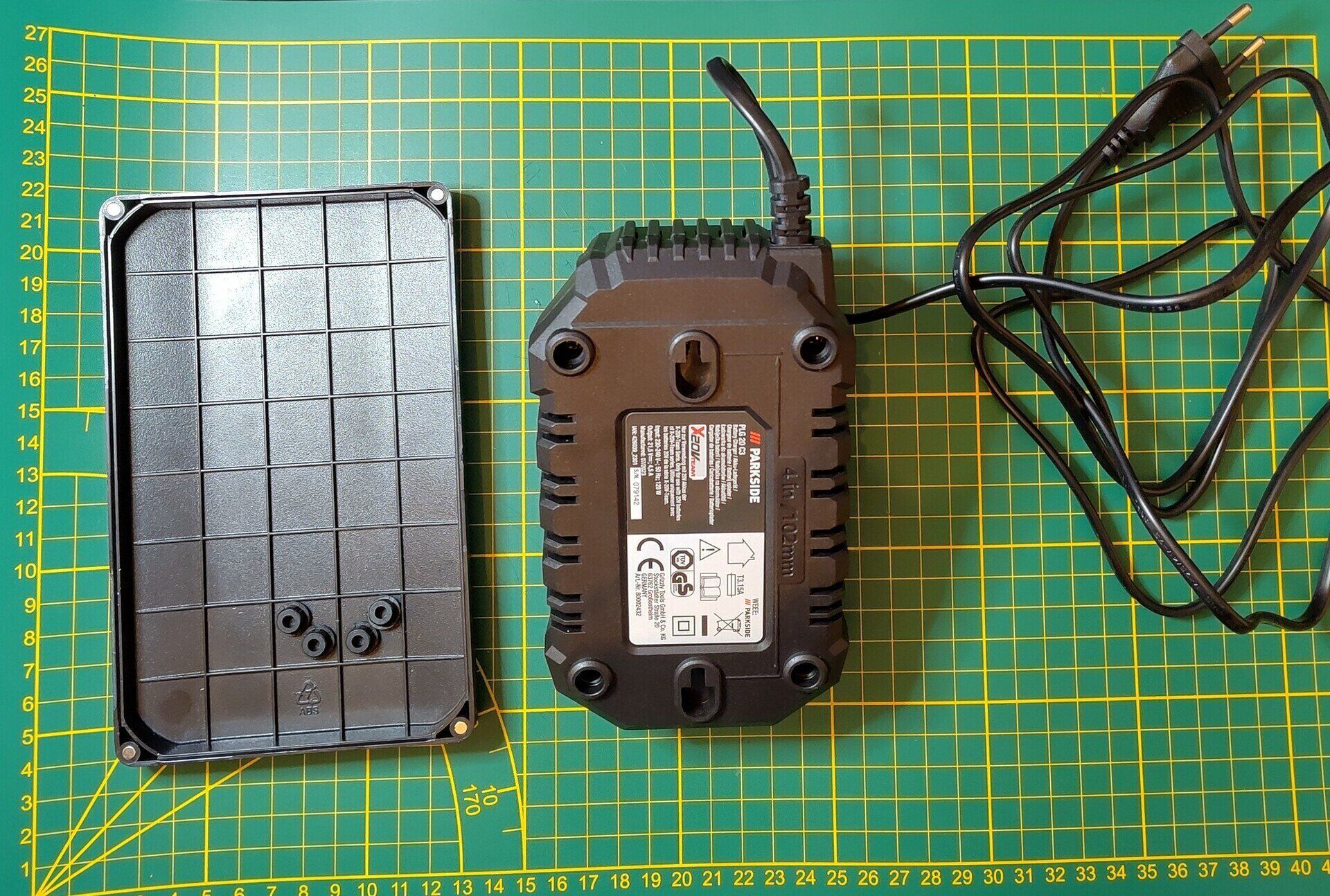 Shows the backside of the Parkside 20V Charger with screw pads removed