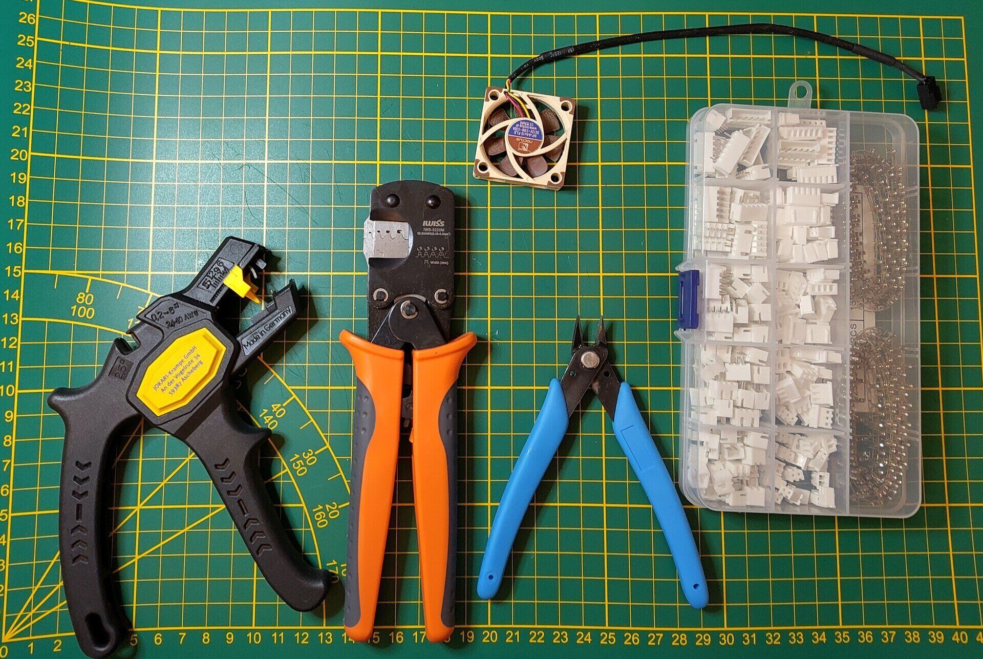 Shows the tools needed for replacing the fan, a cable crimper, a JST crimping tool, a snipping tool, an A4x10 Noctua fan, and a box of JST XH connectors